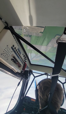 Looking up through the skylight of an aerobatic aircraft at the ground during upset recovery training